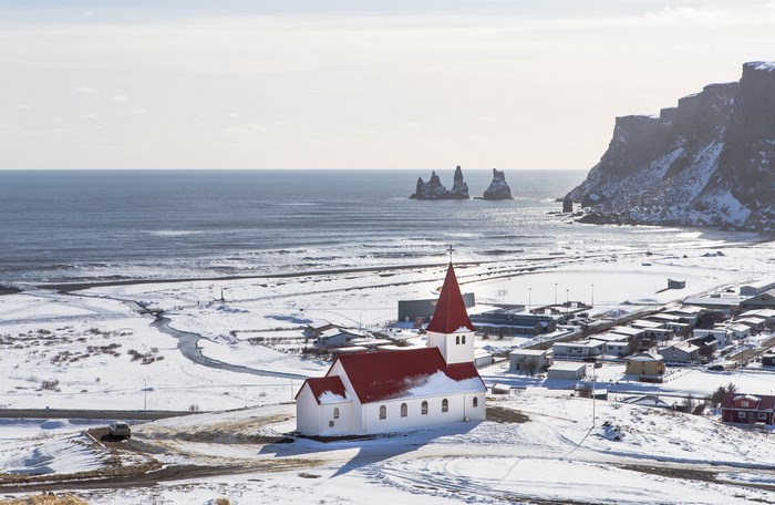 Vik Church in Iceland with Snowy Coastline and Ocean