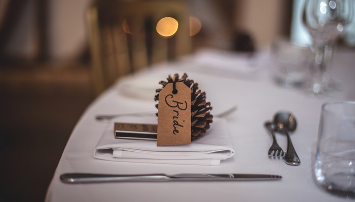 Bride's place setting with pine cone name card