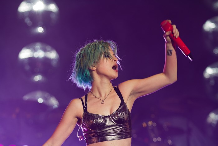 Hayley Williams performing live with red microphone