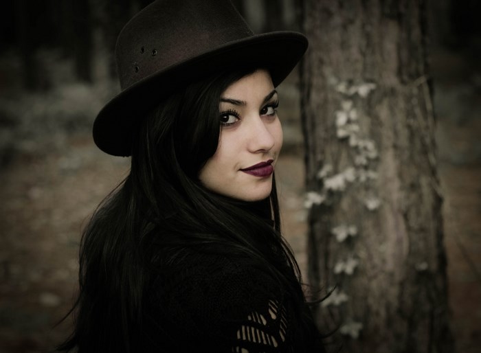 Woman in a cowboy hat with long dark hair