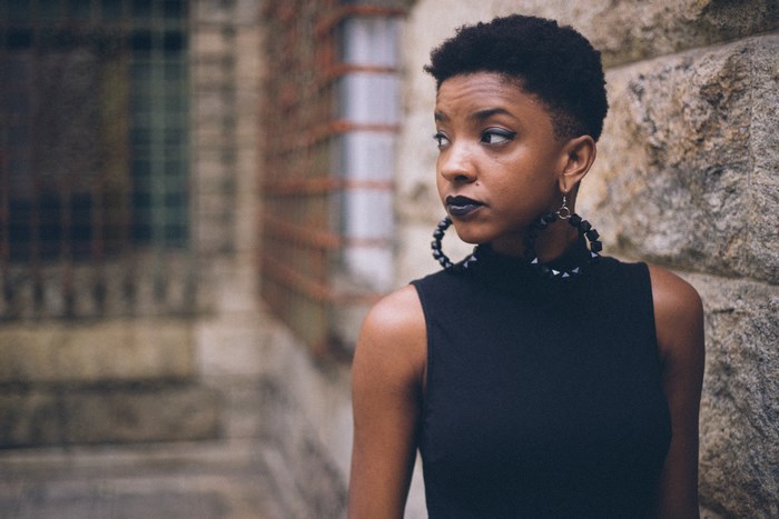 Black woman with short hair and large hoop earrings