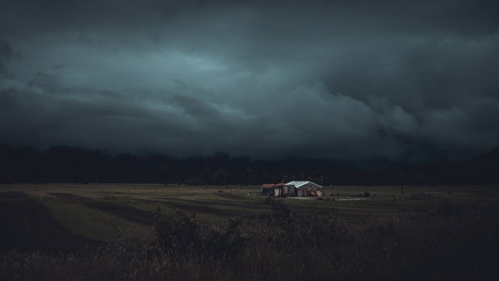 Solitary Farmhouse Under Dark Stormy Skies
