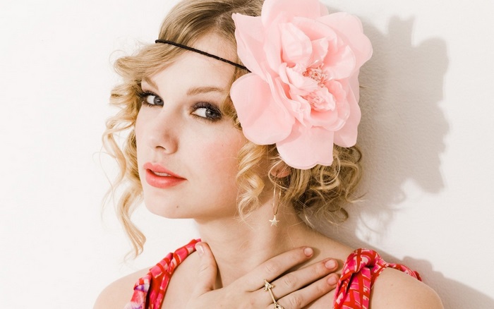 Taylor Swift with a pink flower