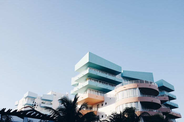 Pastel buildings with balconies in Miami under a clear sky