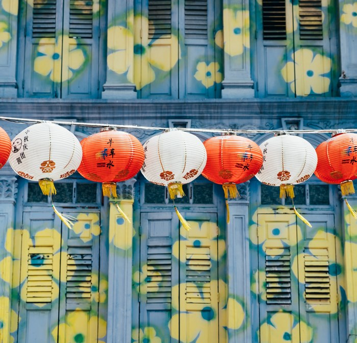 Chinese lanterns hanging in front of a floral facade