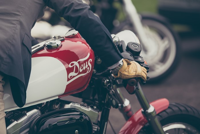Motorcyclist in Suit Riding Red Deus Harley Motorcycle
