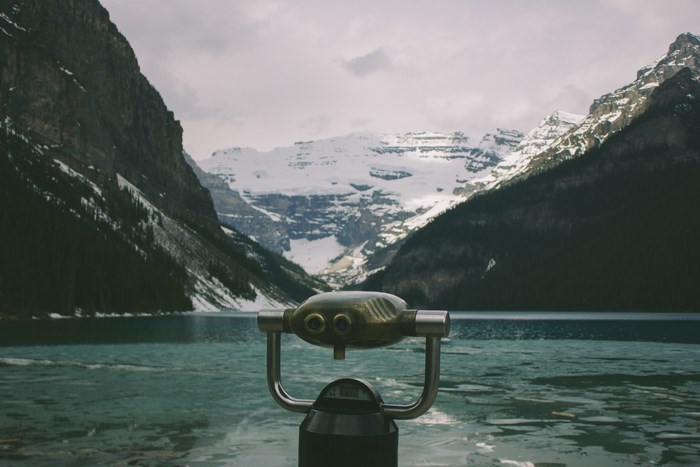Binocular overlooking a snowy mountain lake