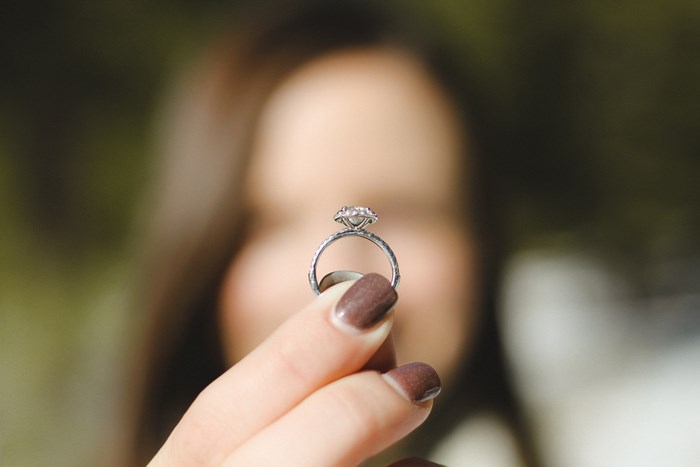 Woman holding a diamond engagement ring