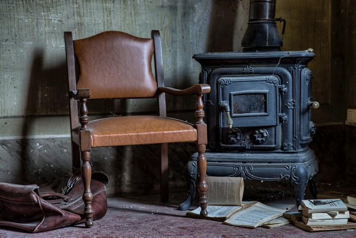 Vintage chair and woodburner with scattered books