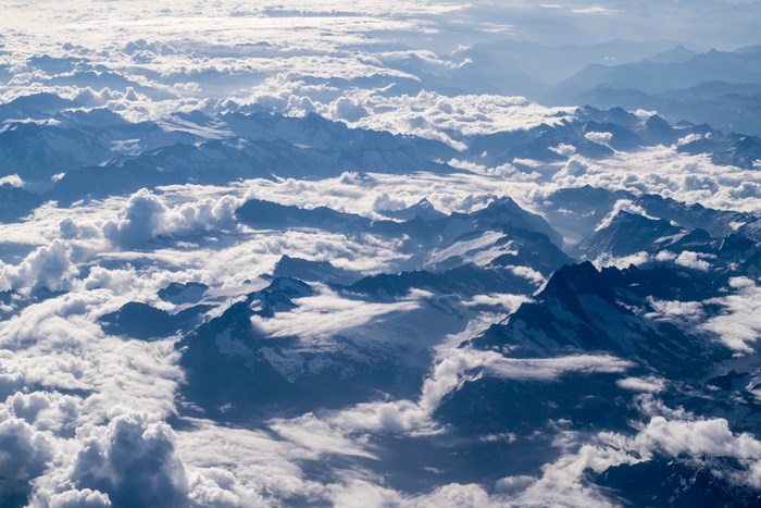 Aerial view of snow-capped mountains and clouds