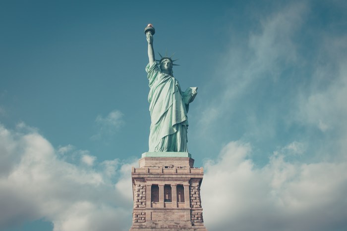 Statue of Liberty against a cloudy blue sky