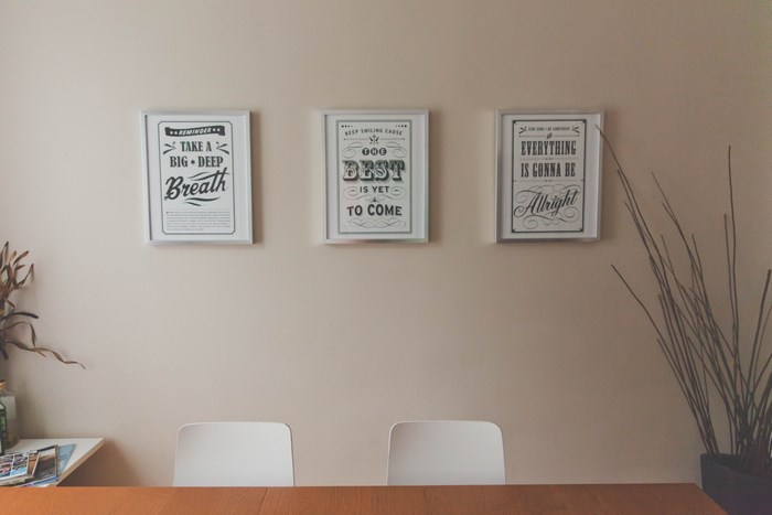 Three framed posters with motivational quotes on a wall