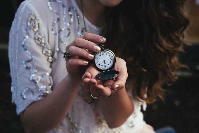 Woman holding a vintage pocket watch