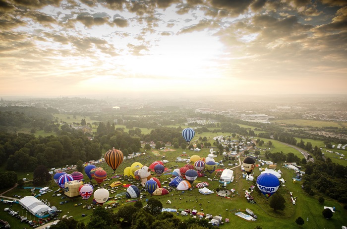 Hot air balloons at a festival at sunrise