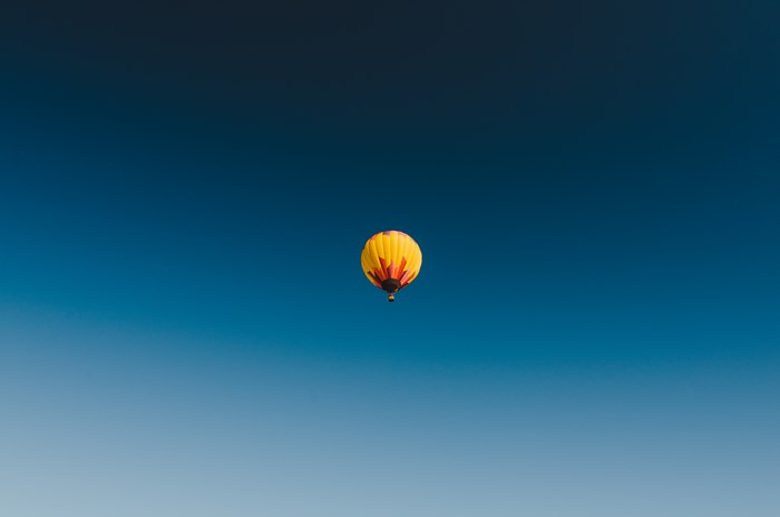 Hot air balloon floating in a clear blue sky