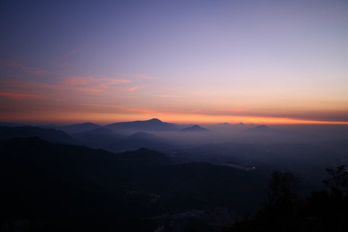 Mountain range at sunrise with pink and orange clouds