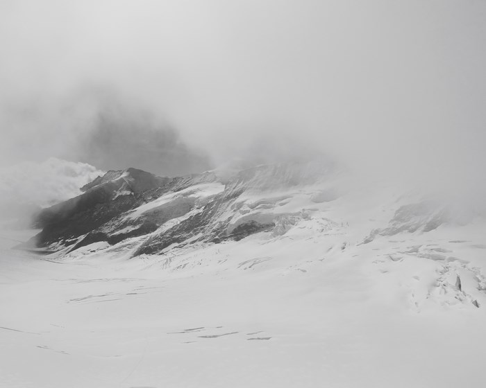Jungfraujoch, Switzerland: Snowy mountain ridge shrouded in clouds