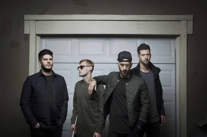 X Ambassadors band members in front of garage door