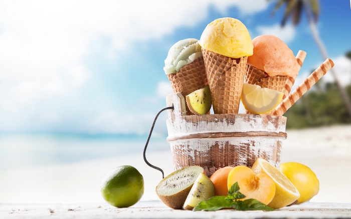 Colorful Ice Cream Cones with Fresh Fruits on Beach
