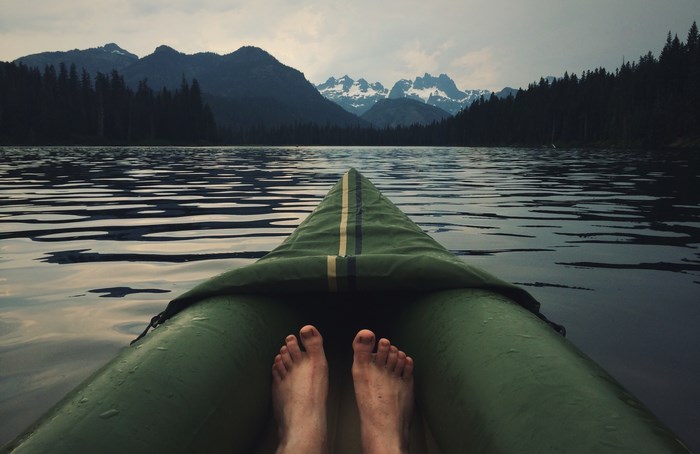 Kayaking on a lake with mountains in the background