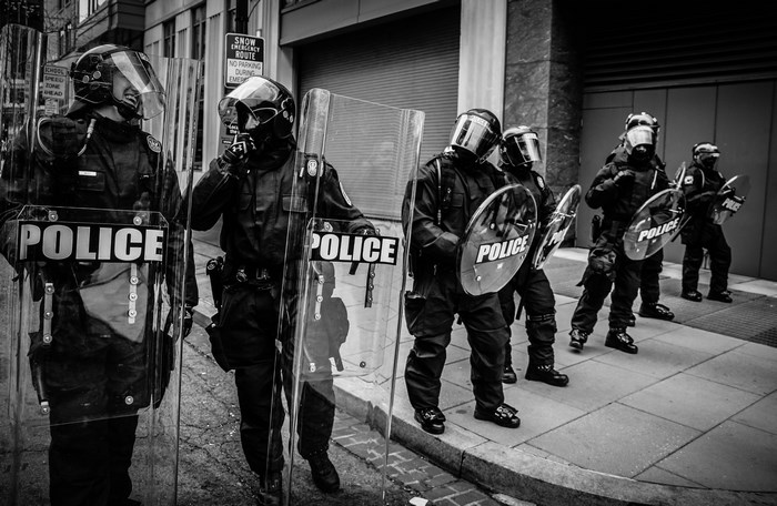 Police officers in riot gear with shields