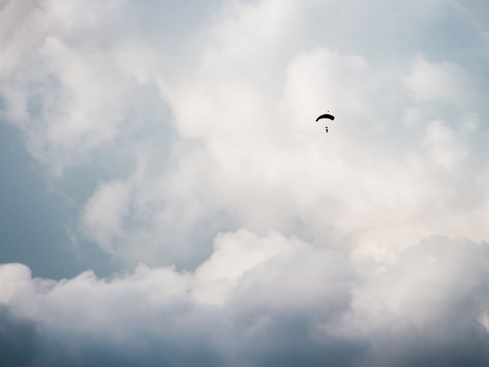 Parachutist freefalling against a cloudy sky
