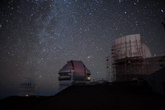 Observatory domes under a starry night sky