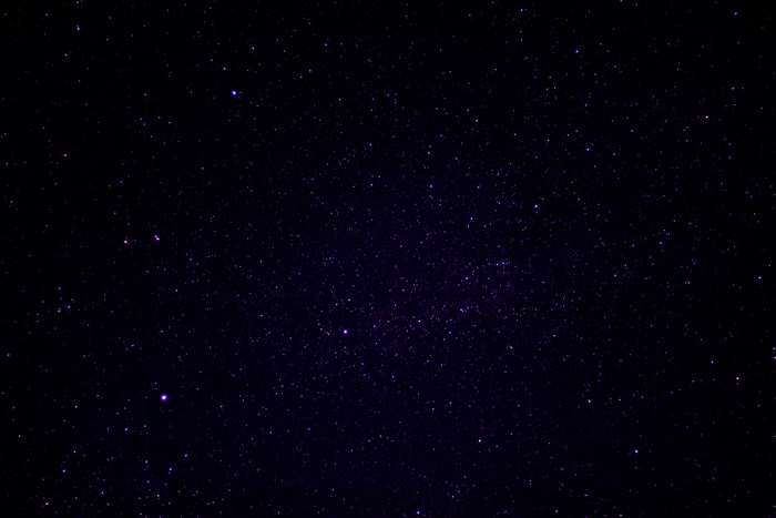 Dark night sky filled with purple stars