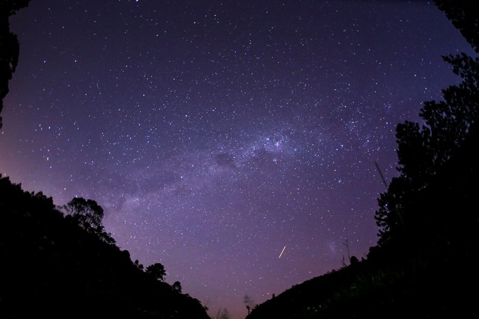 Milky Way galaxy over silhouetted hills at night