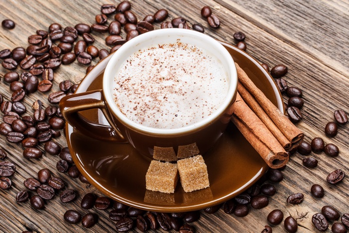 4K Close-up of Coffee Cup with Cinnamon and Sugar Cubes