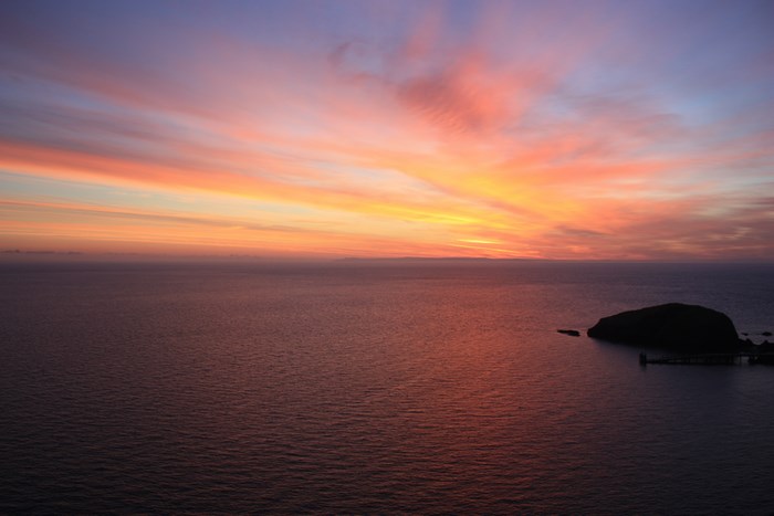 Sunset over the sea with an island