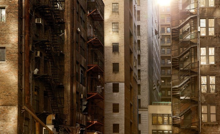 Urban alley with fire escapes and apartment buildings