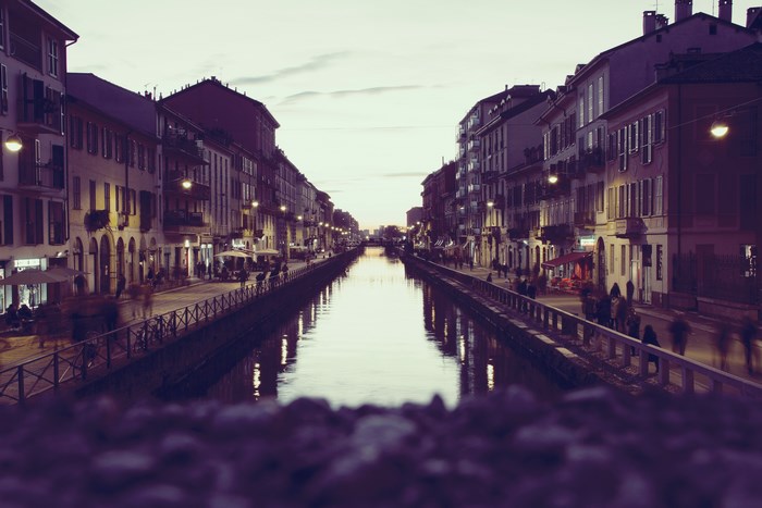 Canal in a city at dusk with buildings and reflections