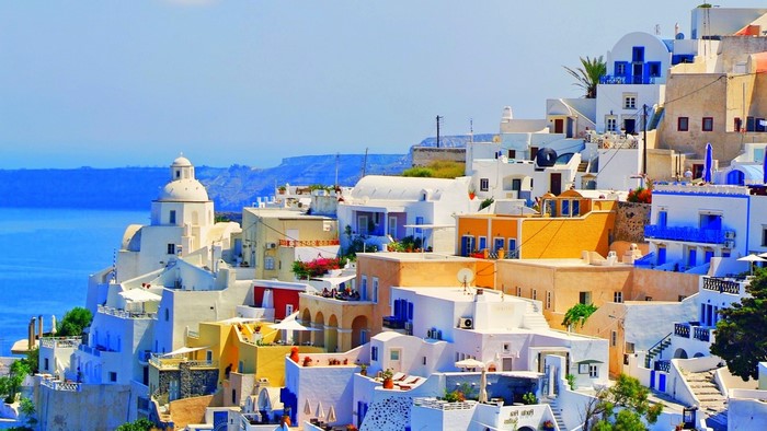 White buildings on a cliff overlooking the sea in Greece