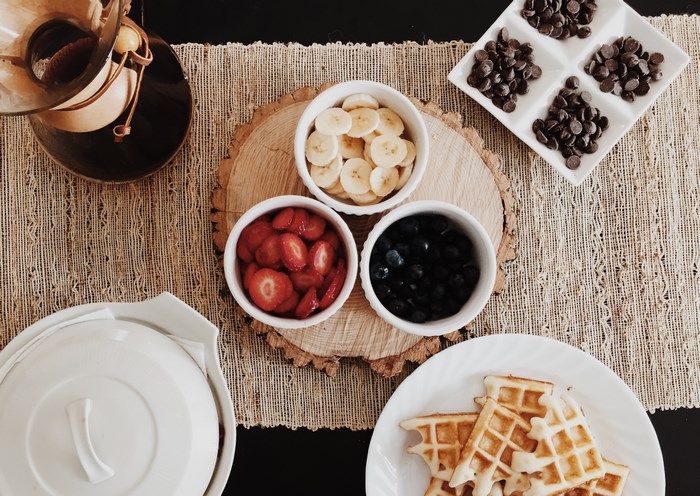 Waffles with fruit and chocolate chip toppings