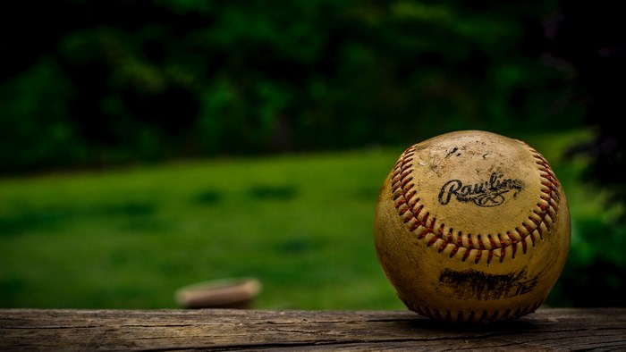 Worn Rawlings baseball on a wooden table