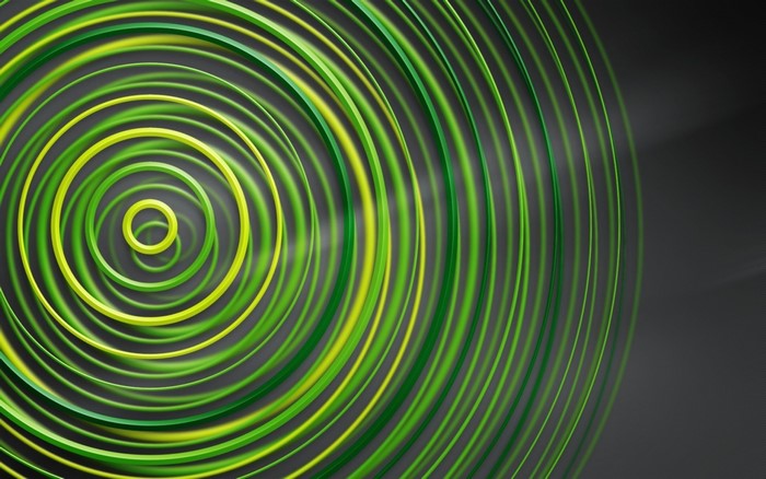 Abstract green and yellow concentric circles on a dark background