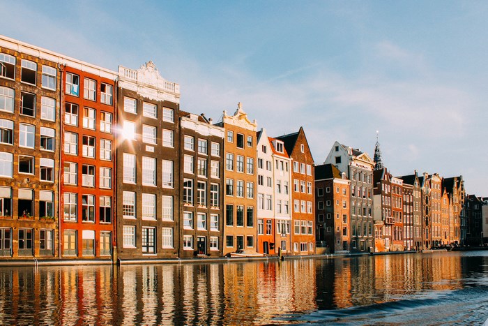 Amsterdam canal with historic buildings and reflections