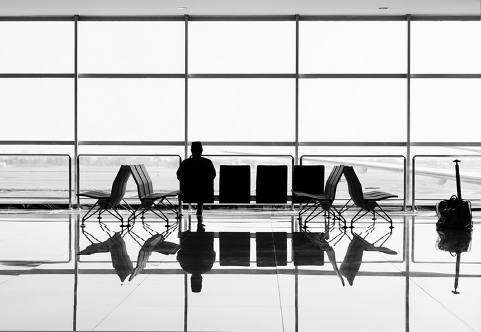 Airport lounge with a person waiting by the window