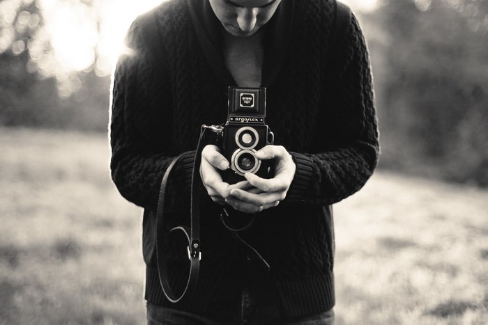 Man holding an Argoflex vintage camera outdoors