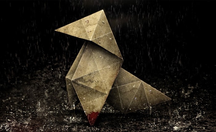 Origami bird in heavy rain