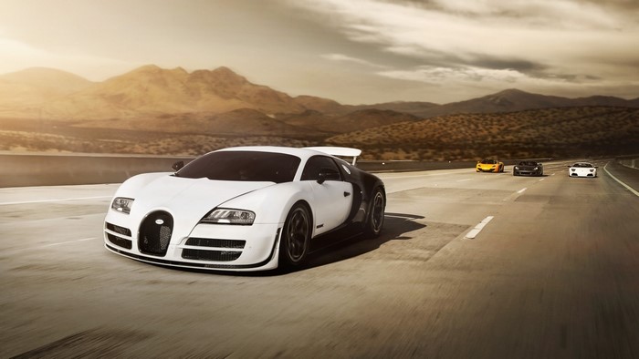 Bugatti Veyron and other supercars on a desert highway