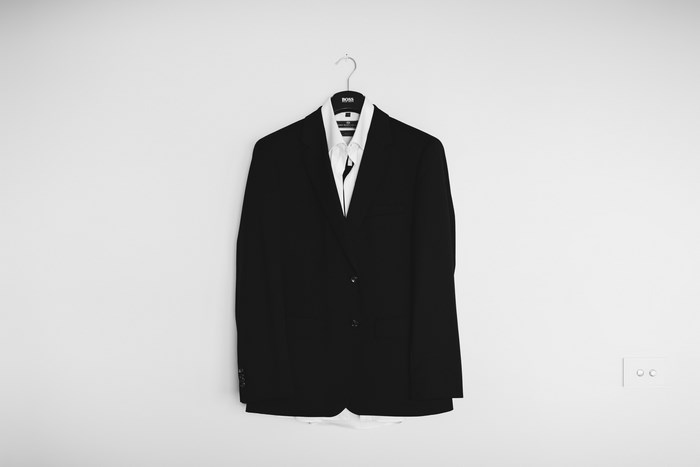 Black BOSS suit jacket and white shirt on hanger