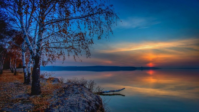 Serene Lake at Sunset with Birch Trees in Russia