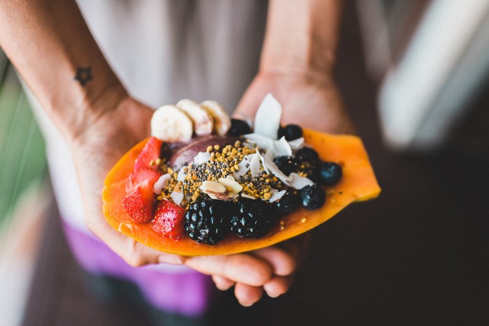 Papaya bowl with berries, banana, and nuts