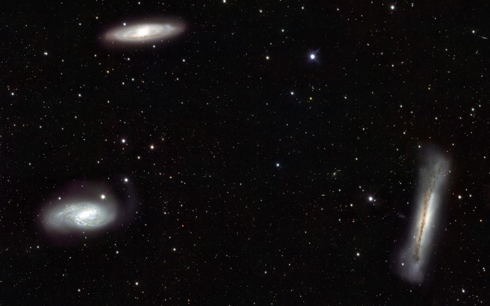 Four galaxies in deep space with stars