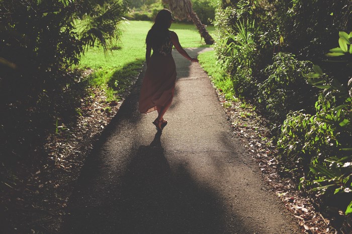 Woman walking on a path in a garden