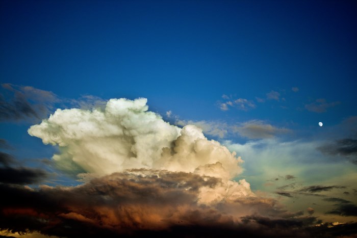 Dramatic Cumulus Cloud Formation at Dusk with Moon