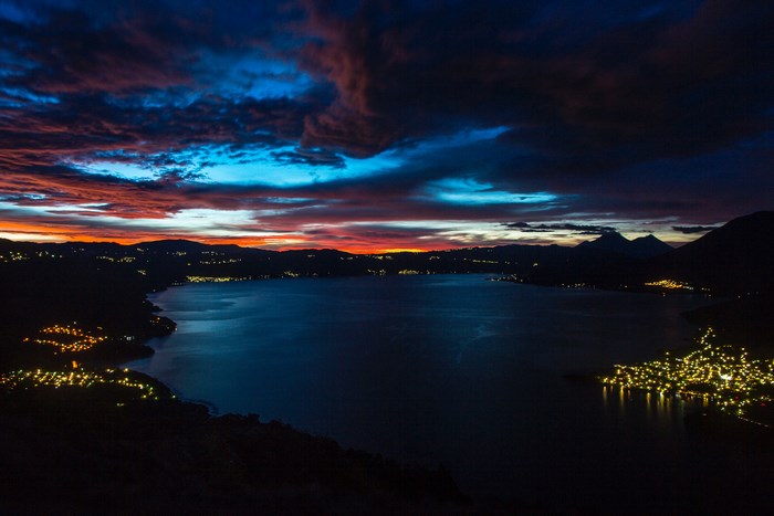 Lake Atitlan at dusk with city lights in Guatemala