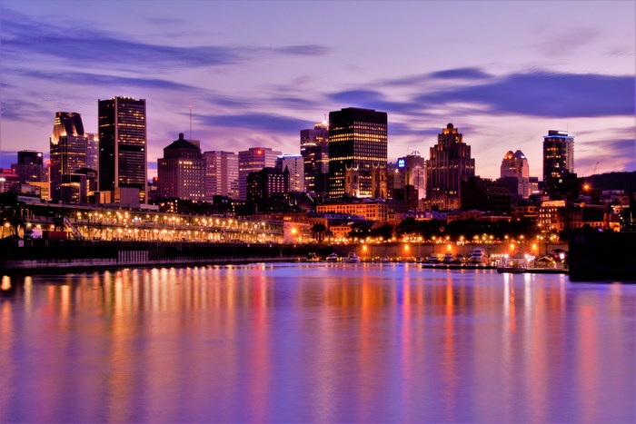 Montreal cityscape at dusk with reflections on the water